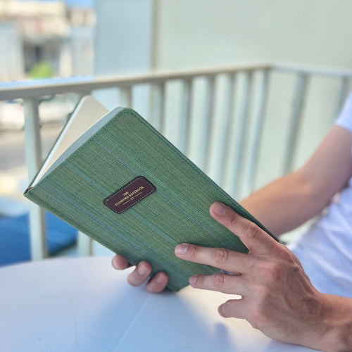 The Marlborough green stripe stitched notebook with brown leather logo patch