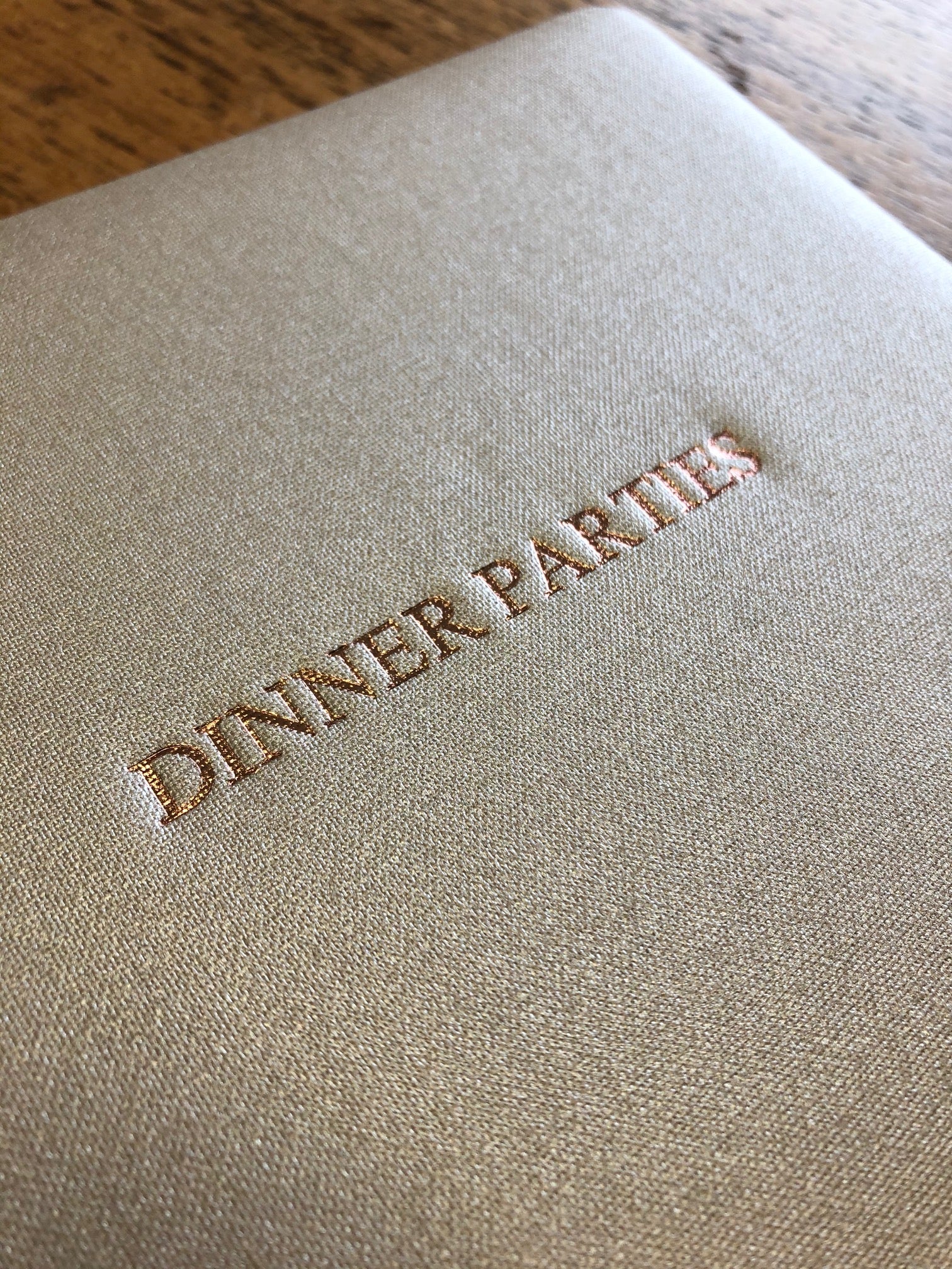Text Image of Metallic Buckram Dinner Party Book in Champagne