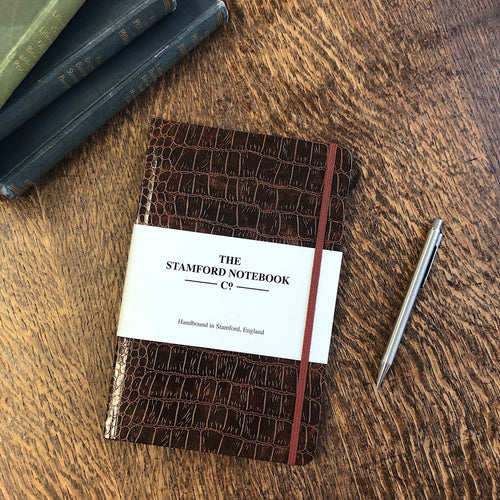 lifestyle image of brown mock croc embossed notebook